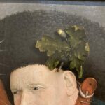 painting of a leaf on a mans hat