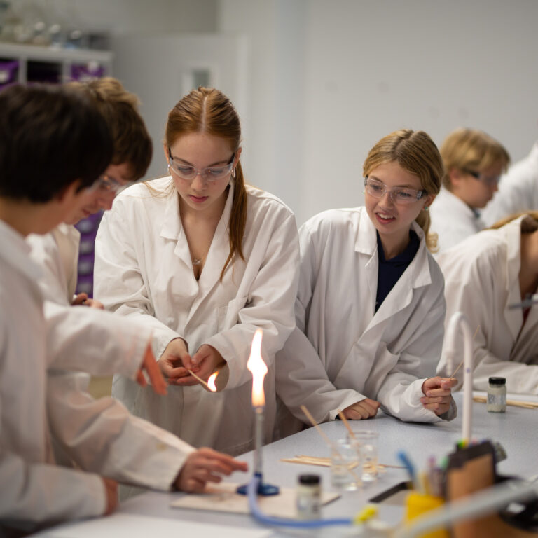 group of school students performing a science experiment